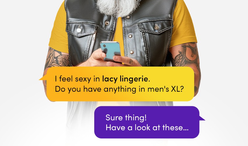 A bearded man with tattoos and a leather gilet asks Lovehoney's AI shopping assistant for lacy lingerie in men's XL